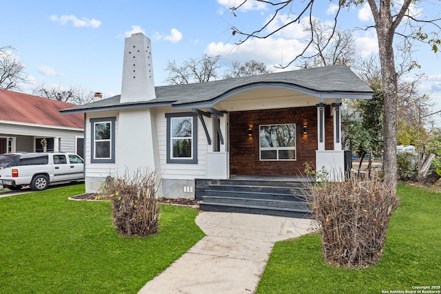 view of front of property with covered porch and a front lawn