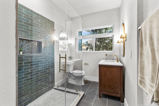 bathroom featuring toilet, tile patterned flooring, a shower with shower door, and vanity