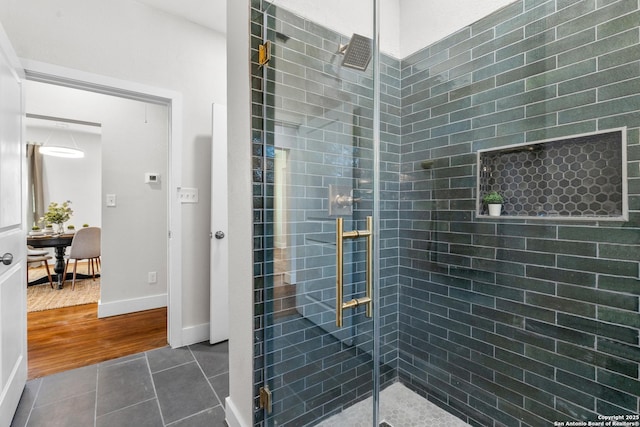 bathroom featuring walk in shower and tile patterned flooring