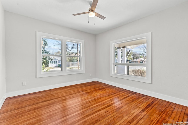 unfurnished room with ceiling fan and hardwood / wood-style floors