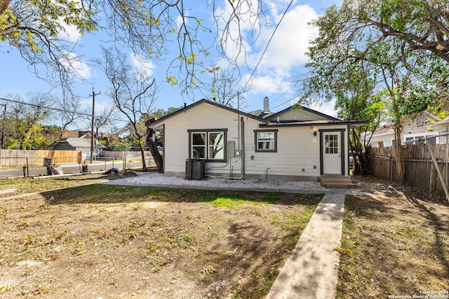 rear view of property with central AC unit