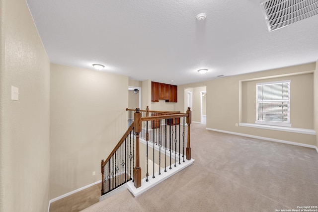 hallway featuring light carpet