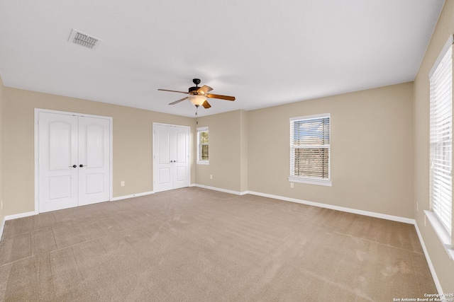 carpeted empty room featuring ceiling fan