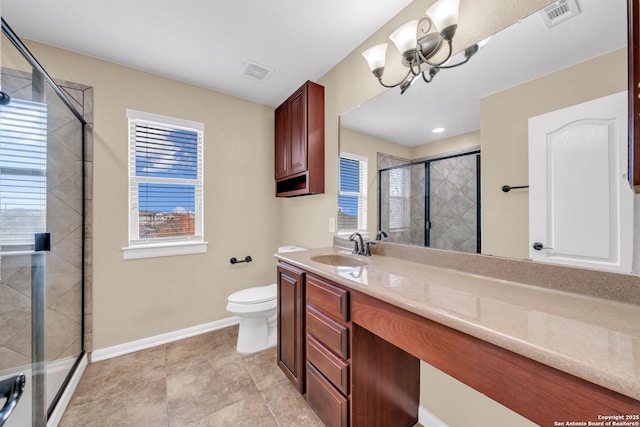 bathroom featuring toilet, tile patterned flooring, an inviting chandelier, a shower with shower door, and vanity