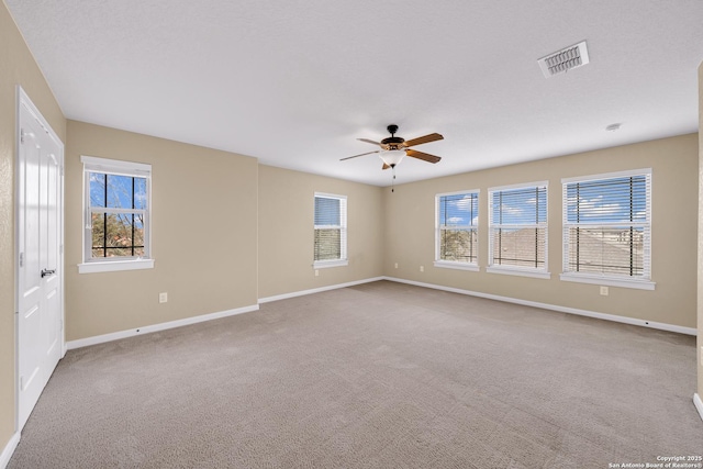 unfurnished room with ceiling fan and carpet flooring