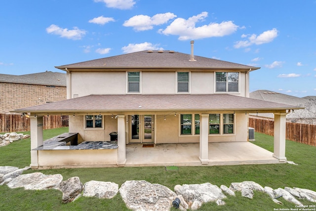 back of house featuring a patio and a yard