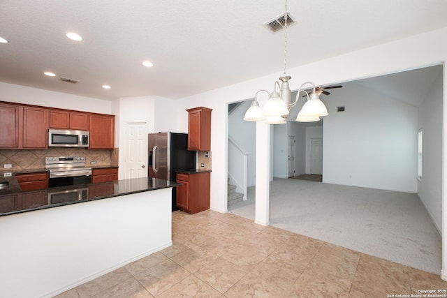 kitchen with light carpet, appliances with stainless steel finishes, hanging light fixtures, a notable chandelier, and backsplash