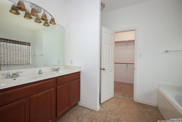 bathroom with a tub and vanity