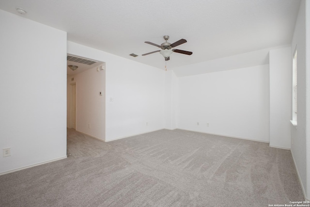 empty room featuring light colored carpet and ceiling fan