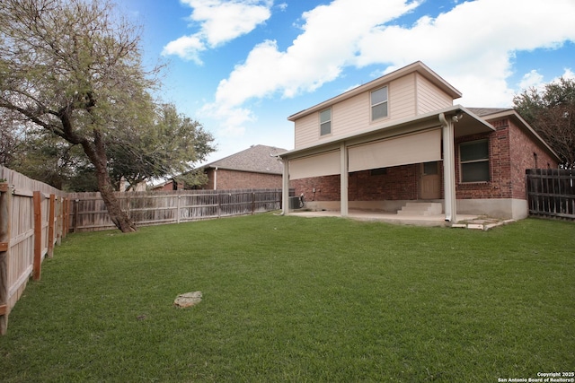 rear view of property with a patio area and a lawn