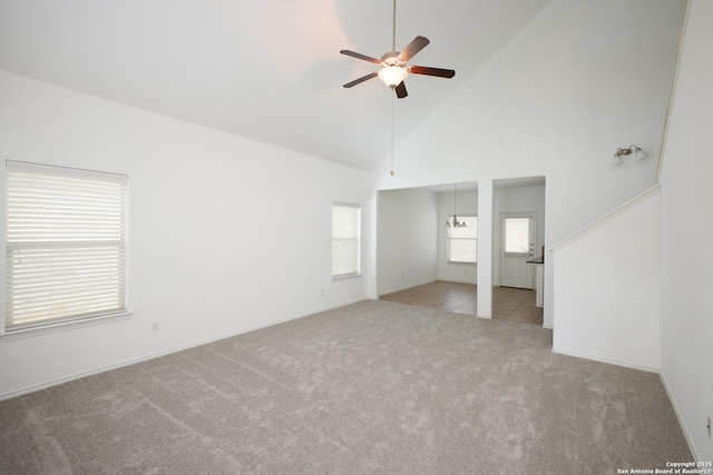 interior space with ceiling fan, light colored carpet, and high vaulted ceiling