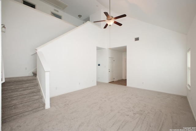 unfurnished living room featuring ceiling fan, light carpet, and high vaulted ceiling