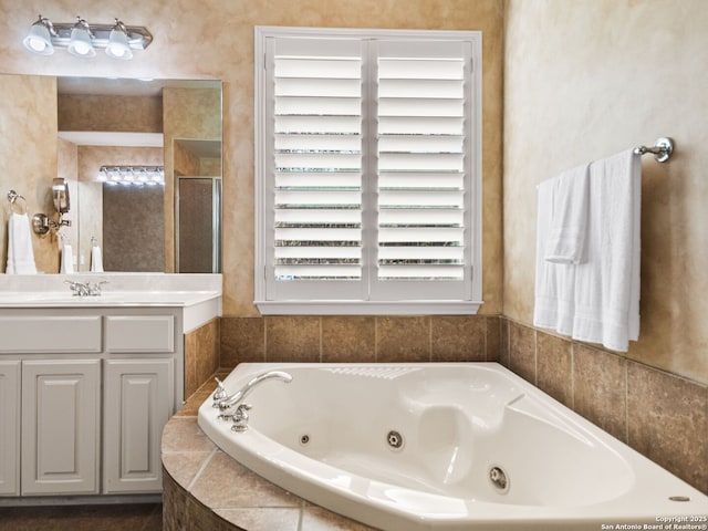 bathroom featuring shower with separate bathtub and vanity