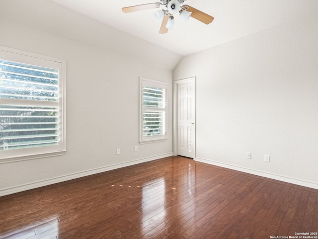 empty room featuring ceiling fan, vaulted ceiling, and wood-type flooring