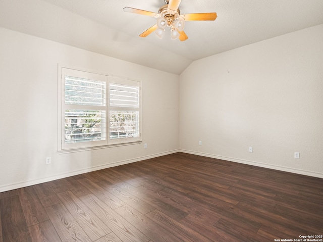 empty room with lofted ceiling, ceiling fan, and dark hardwood / wood-style floors