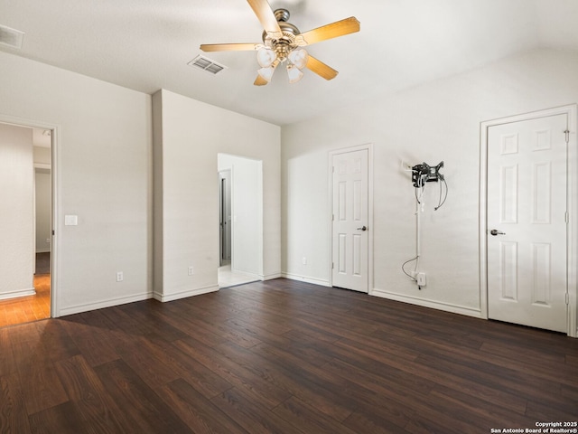 unfurnished bedroom featuring ceiling fan and dark hardwood / wood-style flooring