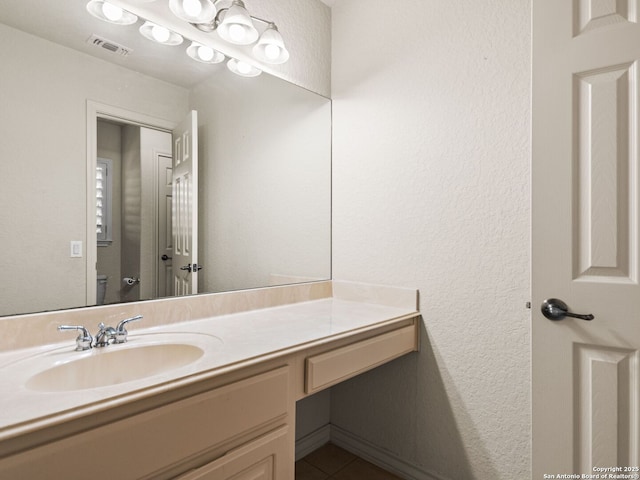 bathroom with toilet and vanity