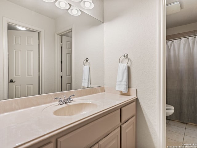 bathroom with a shower with shower curtain, tile patterned flooring, vanity, and toilet