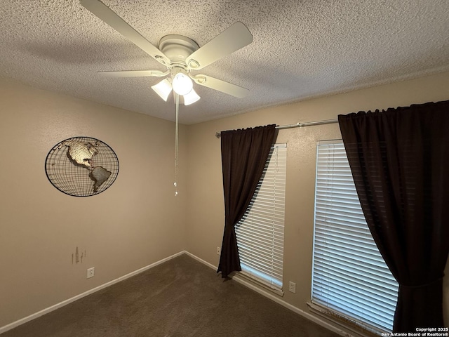 spare room featuring ceiling fan, carpet floors, and a textured ceiling