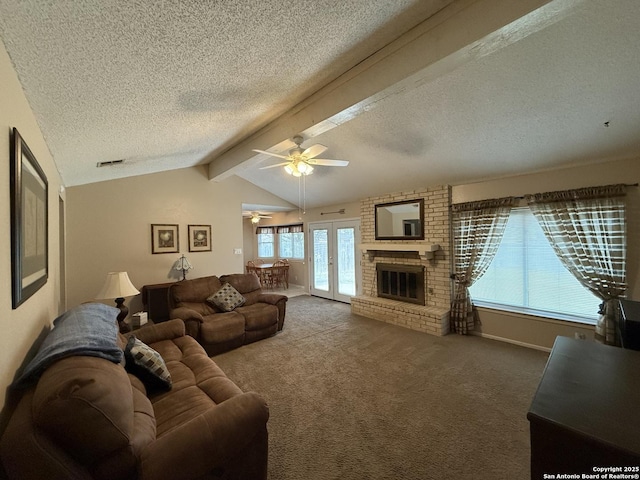 living room with a fireplace, lofted ceiling with beams, carpet, and a textured ceiling