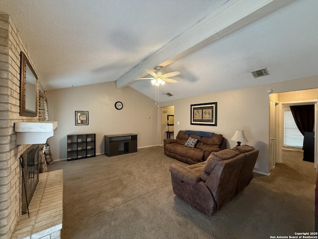 carpeted living room featuring ceiling fan, vaulted ceiling with beams, a textured ceiling, and a fireplace