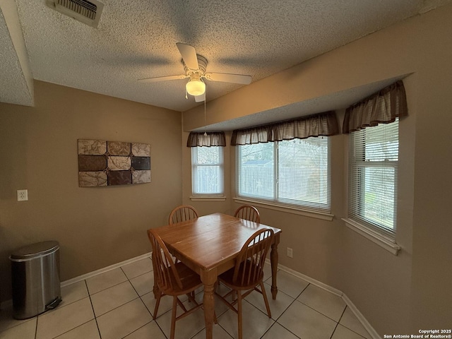 dining room with light tile patterned floors, a textured ceiling, and ceiling fan