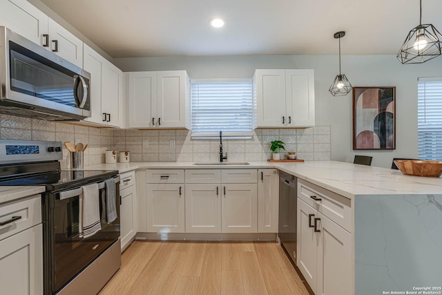 kitchen with sink, stainless steel appliances, and white cabinetry