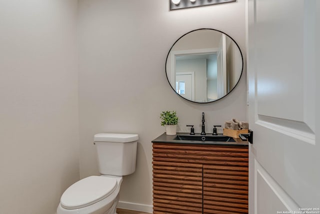 bathroom with toilet and vanity