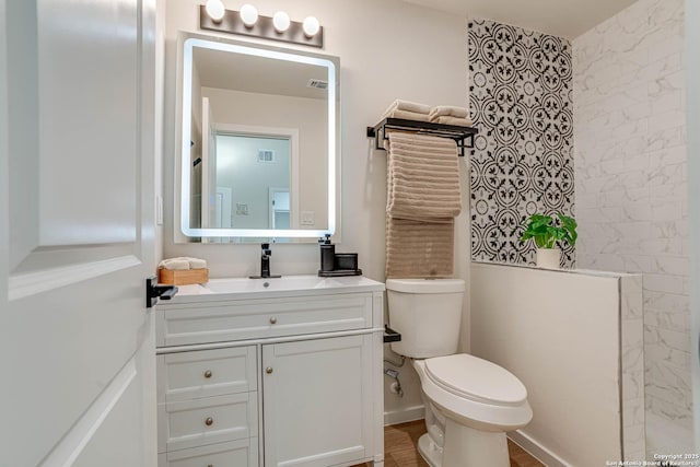 bathroom featuring toilet and vanity