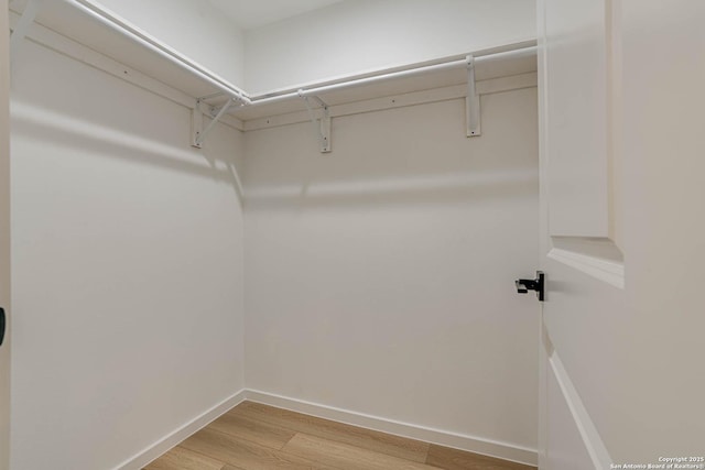 spacious closet featuring light hardwood / wood-style floors