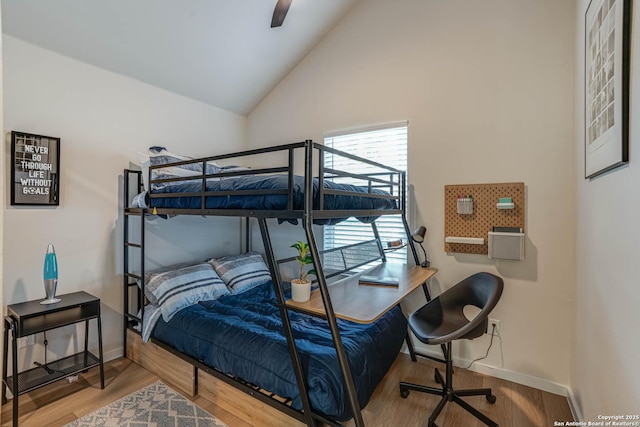 bedroom featuring ceiling fan, hardwood / wood-style floors, and vaulted ceiling