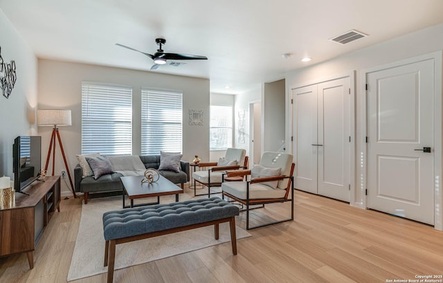 living room with ceiling fan and light hardwood / wood-style floors