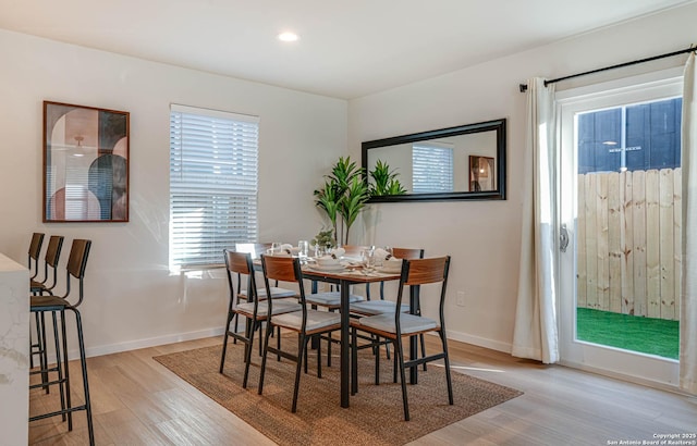 dining space with light hardwood / wood-style flooring