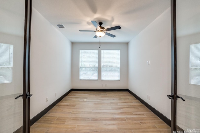 spare room featuring ceiling fan and light hardwood / wood-style flooring