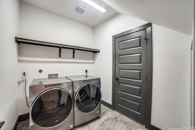 laundry room with separate washer and dryer