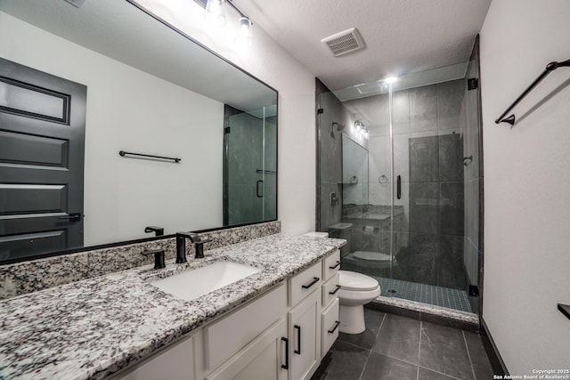 bathroom featuring vanity, an enclosed shower, toilet, tile patterned floors, and a textured ceiling