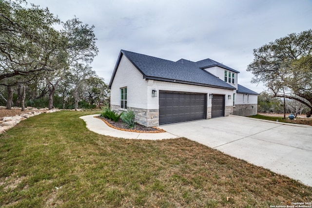 view of side of home featuring a garage and a yard