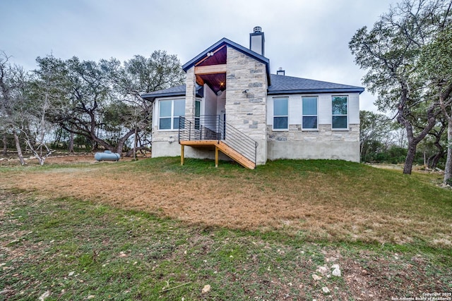 rear view of property featuring a yard