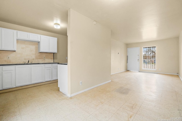 kitchen with white cabinetry and decorative backsplash