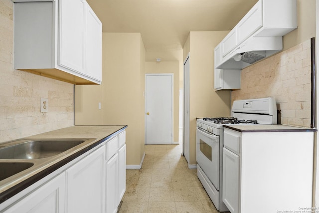 kitchen featuring white cabinetry, decorative backsplash, and white range with gas cooktop