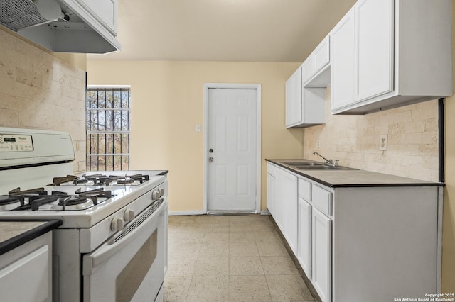 kitchen featuring sink, white cabinetry, custom exhaust hood, decorative backsplash, and white range with gas stovetop