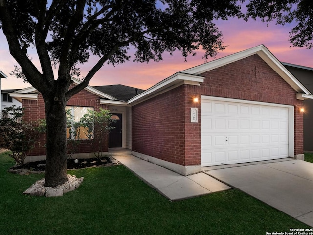 ranch-style house featuring a lawn and a garage