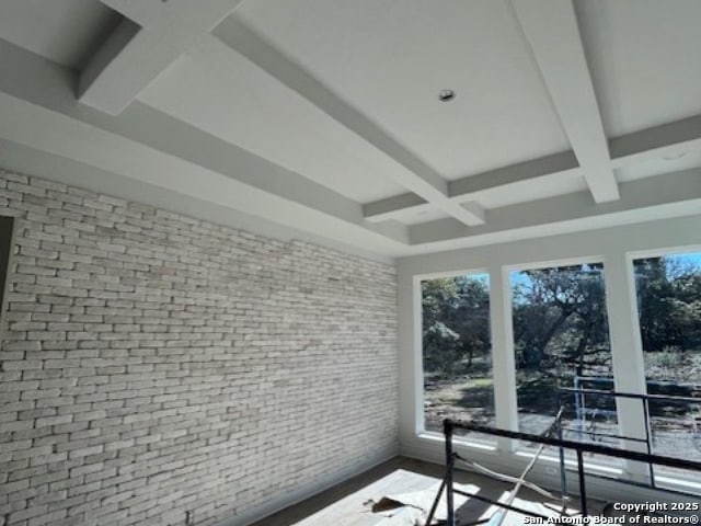 sunroom featuring coffered ceiling and beamed ceiling