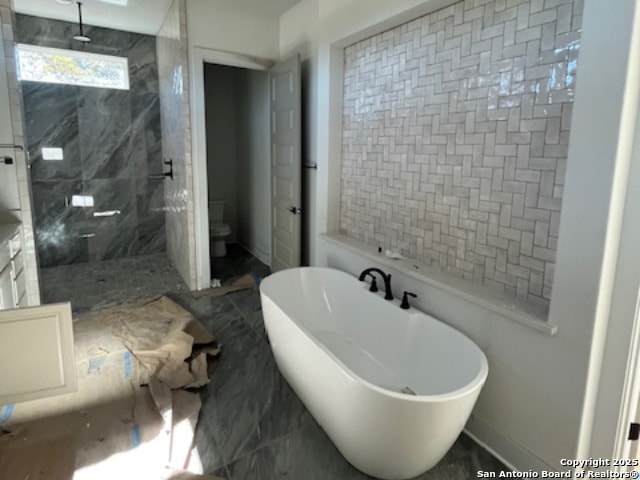 bathroom featuring toilet and plus walk in shower