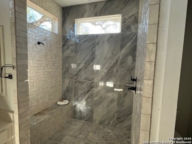 bathroom with a tile shower