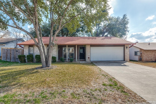 ranch-style home with a garage and a front yard