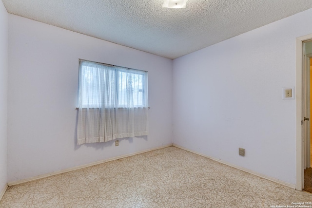 empty room featuring a textured ceiling