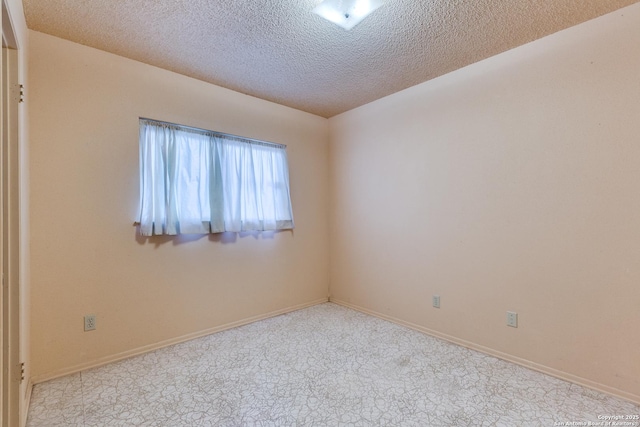 spare room with a textured ceiling