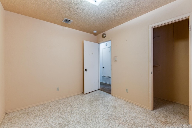 unfurnished bedroom featuring a textured ceiling