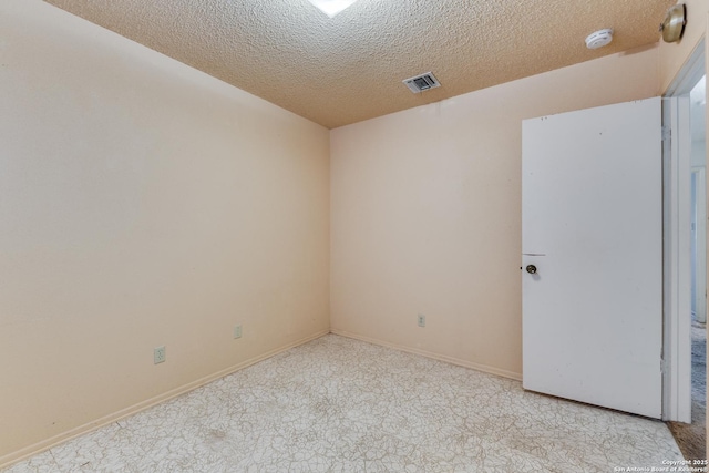 empty room with a textured ceiling